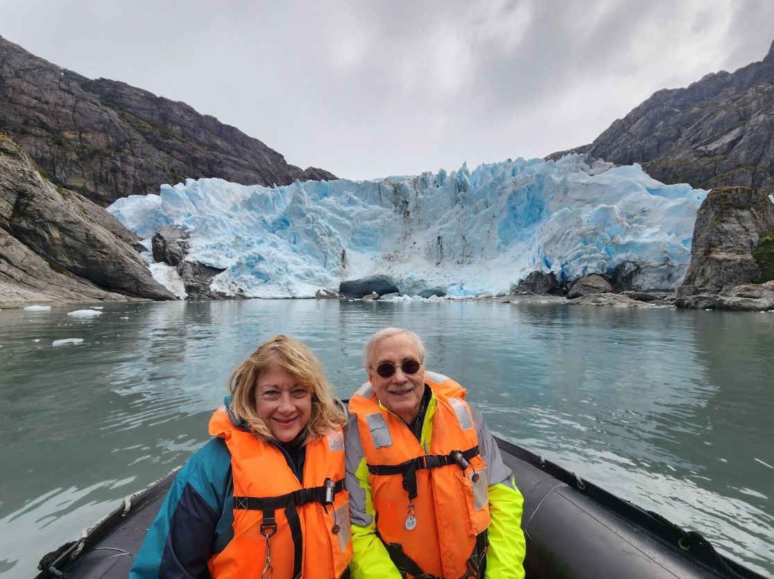 Nina and Jim in front of a glacier.